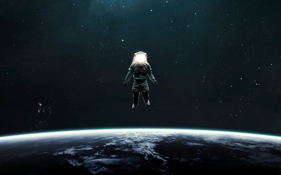 Astronaut at spacewalk orbiting Earth. 5K realistic science fiction art. Elements of image provided by Nasa