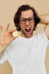 handsome man with glasses gold bitcoin in hands isolated background