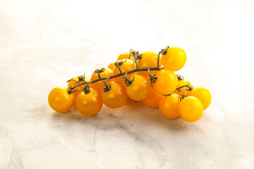 Branch with yellow cherry tomato
