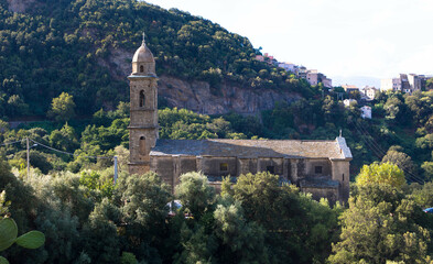 Fototapeta na wymiar Beautiful view of the 16th century Church of Saint Martin in Patrimonio, a little town of Haute Corse with mountains in the Background, Corsica France