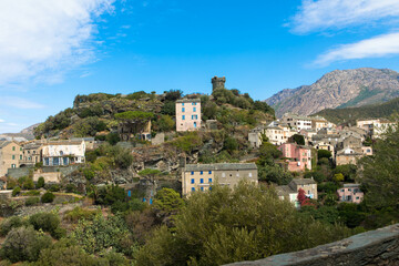 Fototapeta premium A small mountain village with Bavella Mountains in the Background Corsica, France.