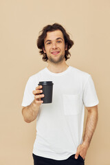 handsome man in a white T-shirt with a black glass in hand Lifestyle unaltered