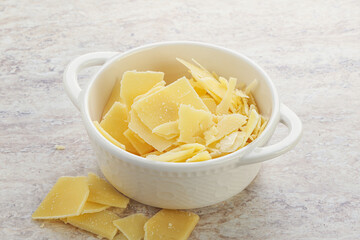 Sliced parmesan cheese heap in the bowl