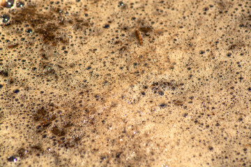Mud and foam in a puddle, background and texture for design and 3d graphics. Blurred background