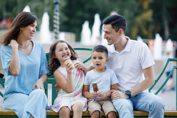 Family on a bench in the summer park
