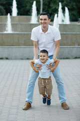 Father is having fun with his son in his arms.