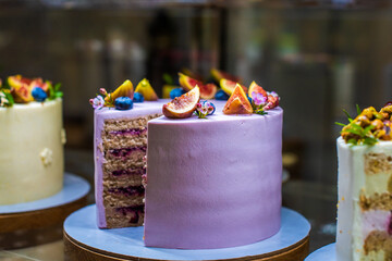 showcase with cakes. appetizing sweets with fruits and berries, figs, blueberries, raspberries