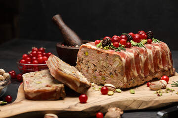 Traditional French terrine covered with bacon on dark wooden background