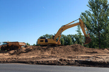 Fototapeta na wymiar Excavator and dump truck repair the road.