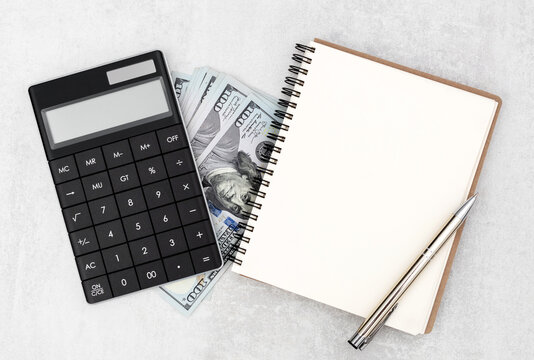 Blank notepad with money and calculator on gray background. Business and financial concept. Copy space.