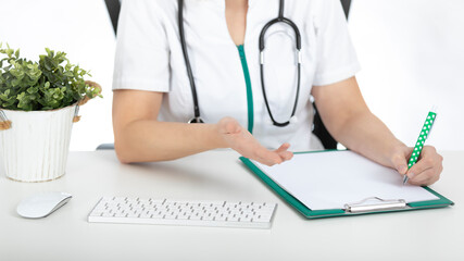 Doctor, nurse at her desk with documents on the table with white background.