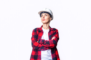 Young woman in construction clothes with folded hands on a light background.