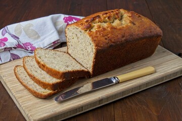 Freshly baked banana bread on wooden cutting board