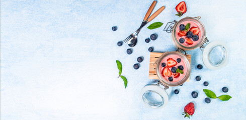 Italian cuisine concept. strawberry panna cotta in a vintage jars with fresh berries. banner format, top view - obrazy, fototapety, plakaty