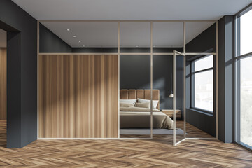 Black and wooden bedroom interior with bed near panoramic window. Copy space
