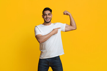 Athletic middle eastern man showing his muscles