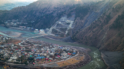 Birds eye view of city of town with beautiful beaches and mountain range on a sunny day. Aerial view of  Town city with Peak.