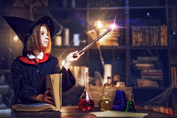 little witch makes a spell with a magic wand. Halloween party. Cosplay Harry Potter. Happy childhood