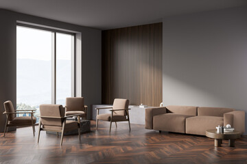Dark living room interior with empty grey wall, four armchairs