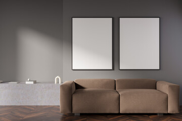 Dark living room interior with two empty white posters, sofa