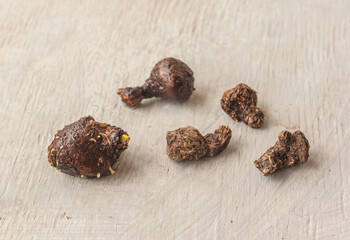 Anemone coronaria tubers with roots on  gray table.