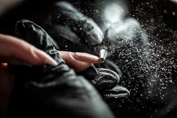  Manicurist is applying electric nail file drill to manicure on female fingers. Woman getting nail manicure. Beautician file nails to a customer. professional manicure tool © Надія Коваль