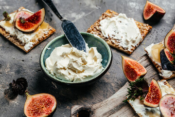 Bowl of cream cheese. Canape or crostini Fig, cream cheese and honey sandwiches. Food recipe background. Close up