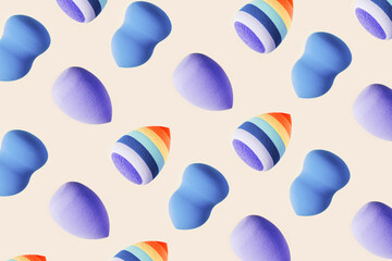 Pattern with cosmetic sponges blue and striped bright color. Makeup sponge beauty blender, brush for face Close up puffs different shape. Backgrounds for salon fashion beauty makeup.
