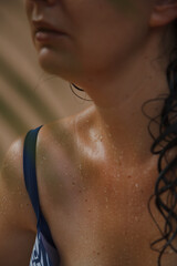 Water drops on body of woman in swimsuit