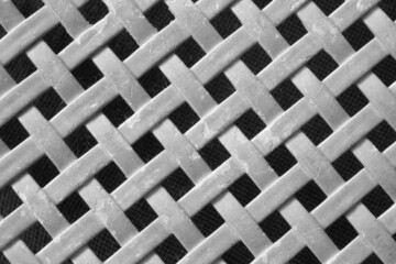 Gray plastic mesh pattern on a black background