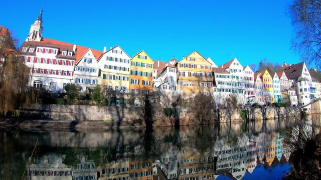 Steady shot of the scenic historic, colourful buildings at the waterfront of the Neckar River in Tübingen in Southern Germany in winter