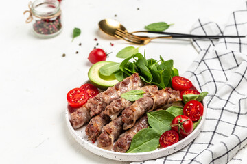 Bacon wrapped minced meat with spinach, avocado and cherry tomato, Healthy fats, clean eating for weight loss. Long banner format. top view