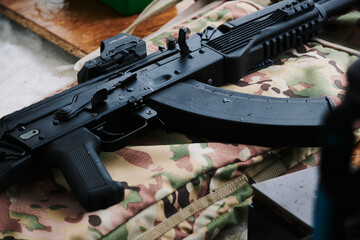 The Kalashnikov assault rifle lies neatly on a special cover in the colors of 