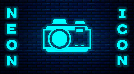 Glowing neon Photo camera icon isolated on brick wall background. Foto camera. Digital photography. Vector