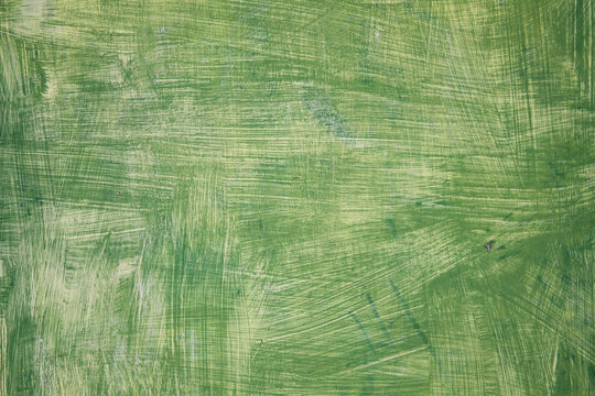 Background abstract green texture of an old distressed blank wood plank board painted with a scratched textured paint wash, stock photo image with copy space