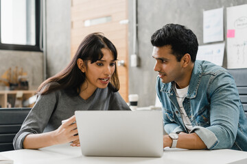 Multiracial group of young creative people in casual wear meeting brainstorming ideas about new paperwork project colleagues working together planning success strategy enjoy teamwork in small office