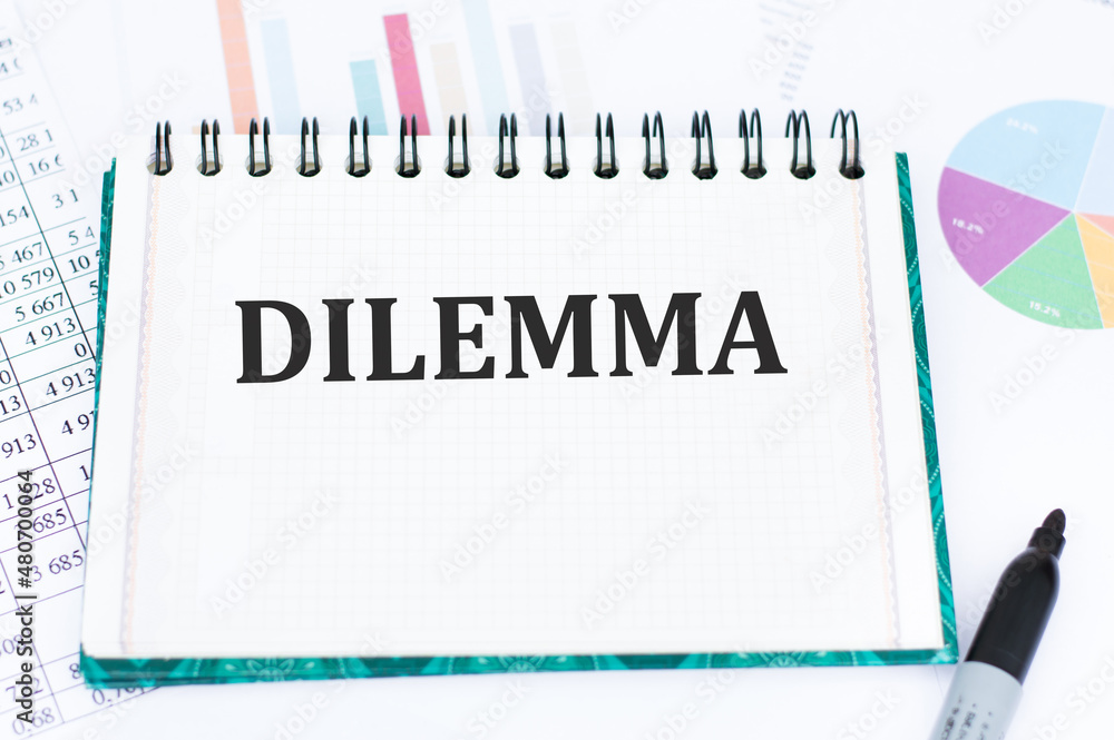Poster text dilemma on notepad with reports and financial charts