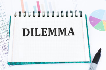 text DILEMMA on notepad with reports and financial charts