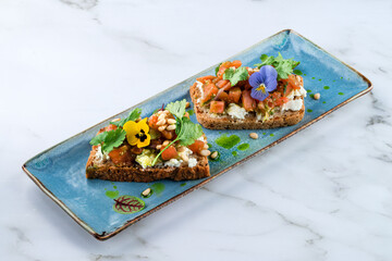 Two guacamole and salmon toasts