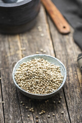 Whole pepper spice. White peppercorn grain in bowl