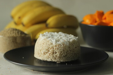 Steamed barnyard millet flour cake or barnyard millet puttu served with mango slices and plantains