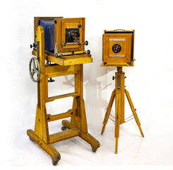 Two vintage large wooden cameras on a white background