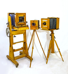 Three vintage large wooden cameras on a white background