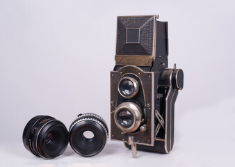 Vintage photo camera with two lenses on a white background