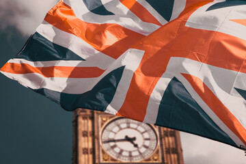 flag of UK waving in front of Big Ben and Westmister Abbey  London  UK