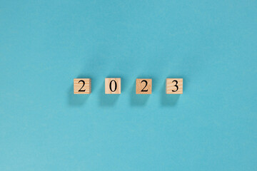 2023 year on wooden blocks on light blue background	