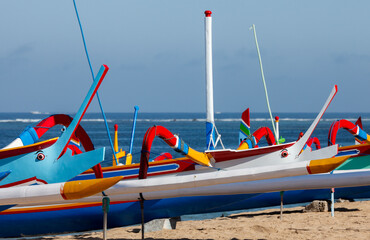 Indonesia, Bali, brightly painted fishing outriggers on the beach at Sanur
