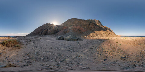 full seamless spherical hdri 360 panorama view of sunset in desert with sun shines from behind the...