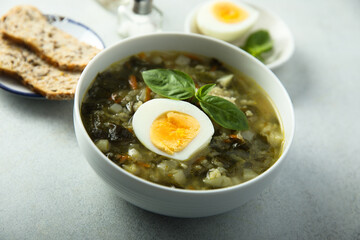 Traditional homemade green soup with hard boiled eggs	