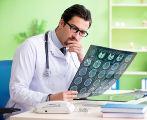 Doctor radiologist looking at x-ray scan in hospital